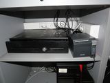 a computer and a printer on a shelf in a room