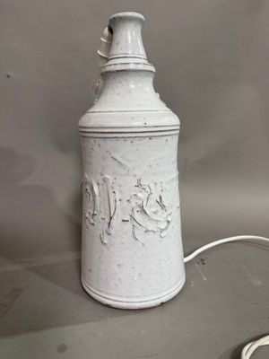 a white canister with writing on it sitting on a table