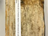 a piece of wood with a piece of paper attached to it