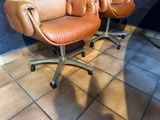 two chairs that are sitting on a tile floor