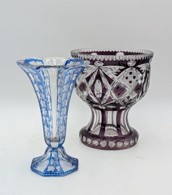 two vases sitting next to each other on a white surface