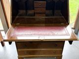 a wooden desk with a drawer on top of it