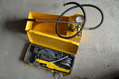 a yellow box with a hose and a yellow box with a hose in it