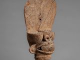 a close up of a sculpture of a head on a stand