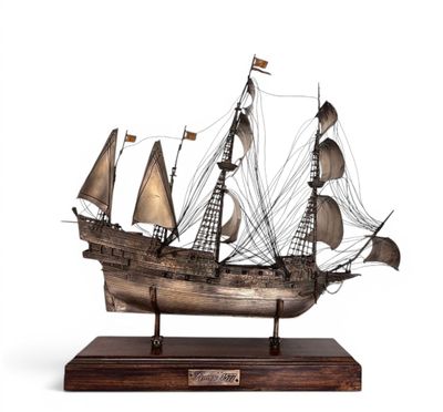 an image of a model of a ship on a wooden base