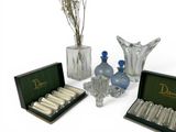 a lot of glass bottles and vases that are on the table