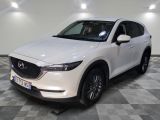 the white mazda cx - 5 is parked on a checkered floor