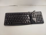 a black keyboard and mouse sitting on a white table