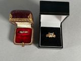 a small box with a ring inside of it on a table