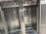 two refrigerators that are in the middle of a room