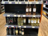 many bottles of alcohol on the shelves in the store