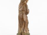 a wooden statue of a woman holding a child