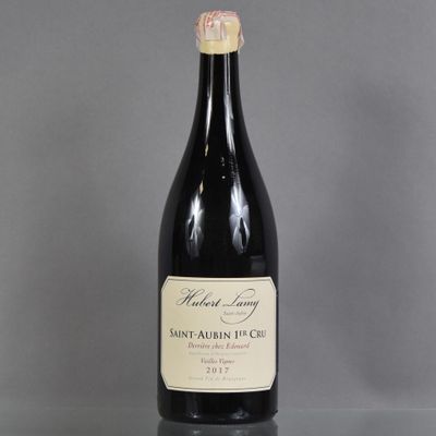 a bottle of wine sitting on top of a glass table