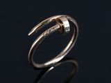 a close up of a silver ring on a black surface
