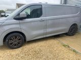 a silver van parked in front of a garage door