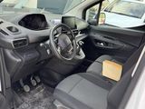 the interior of a car with the door open and the driver ' s seat down