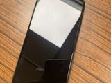 un téléphone portable noir posé sur une table en bois