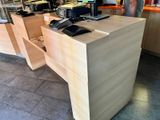 a desk with a phone and a laptop on top of it