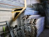 a pile of metal bars stacked up in a room