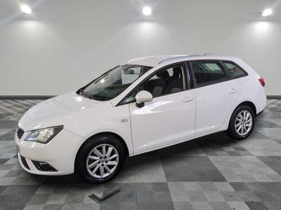 the white car is parked on a checkered tile floor
