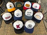 several hats are arranged on a table in front of a fireplace