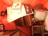 a pile of old luggage and a television in a box