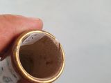 a person holding a small cup in their hand