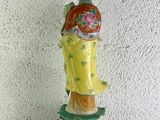 chinese figurine of a woman in a yellow dress holding a fan