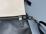 a close up of a black and white purse with a zipper