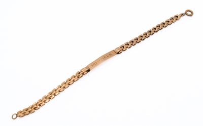 a close up of a gold bracelet on a white background