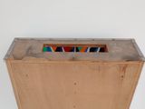 a wooden box with a stained glass window in it