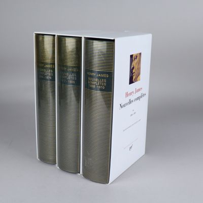 three books in a white box on a gray surface