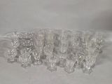 a lot of clear glass vases sitting on a white surface