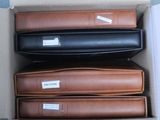 four suitcases in a box with labels on them