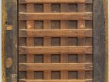 a close up of a wooden window with a grid pattern on it