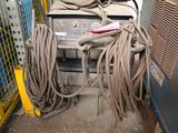 an image of a bunch of wires and a machine in a garage