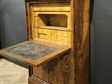an old wooden desk with a drawer on top of it in a room