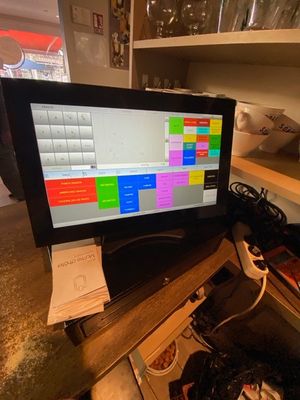 a computer monitor sitting on top of a wooden desk