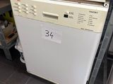 a white dishwasher sitting on a counter in a kitchen