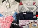 a pile of clothing on a table with a price tag