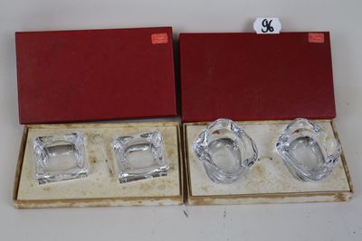 two glass ashtrays in a red box on a white surface