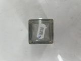 a bottle of perfume sitting on a white surface