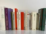 a lot of books that are lined up on a table