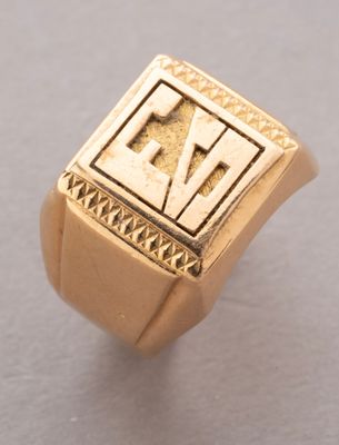 an image of a gold signet ring with the letter e on it