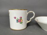a close up of a cup and a bowl on a table