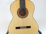a close up of a guitar on a stand against a white background