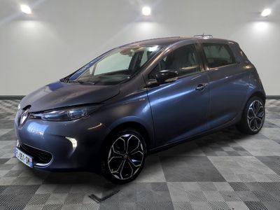 the blue car is parked on a checkered floor in a garage