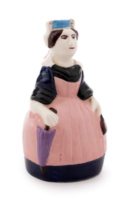a figurine of a woman wearing a pink dress and holding an umbrella