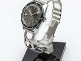 an image of a wrist watch on a stand on a white surface