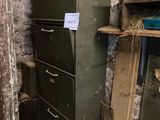 a refrigerator in the corner of a room with a sign on it
